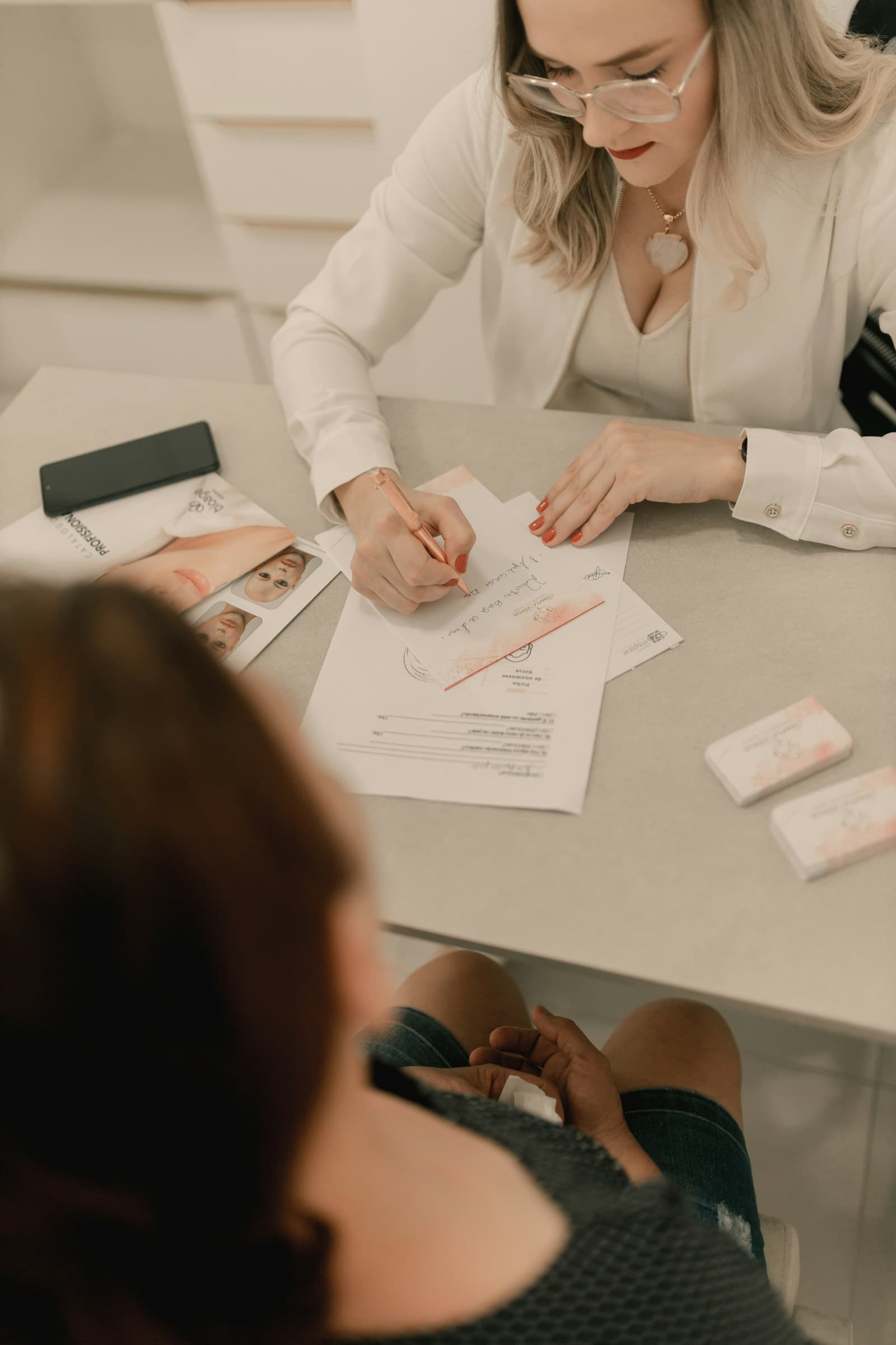 A clinician writing up a treatment plan with a client